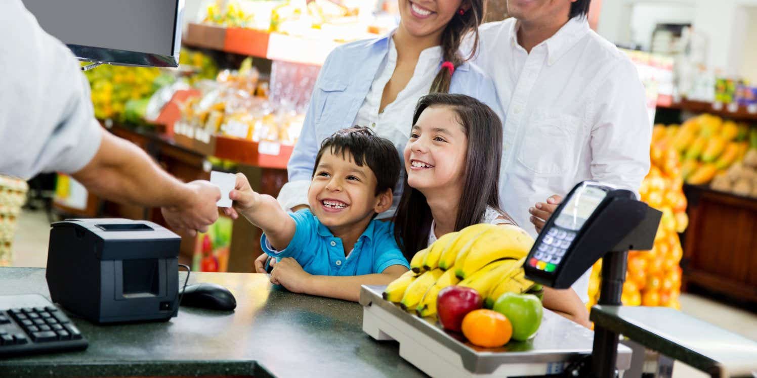 Family shopping and paying with a card