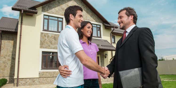 couple-and-estate-agent-outside-property