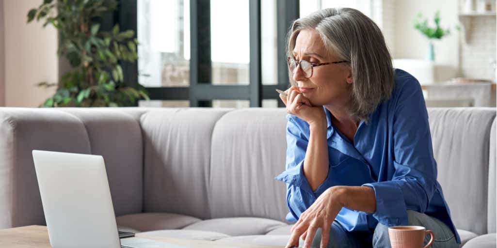 A woman looking at a laptop 