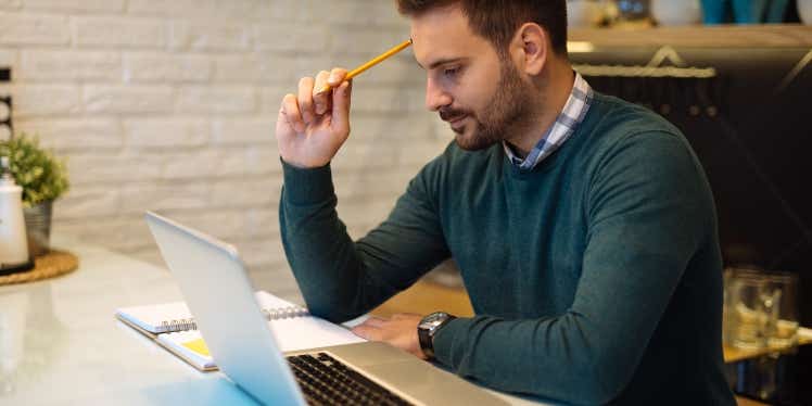 Individual sitting down to write a budget to take control of his spending