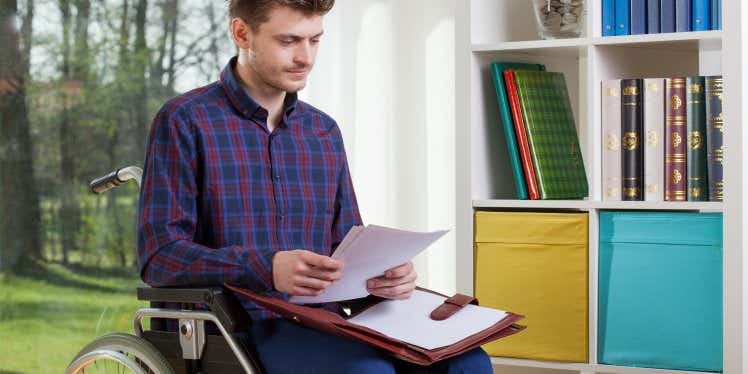 disabled-man-looking-at-paperwork