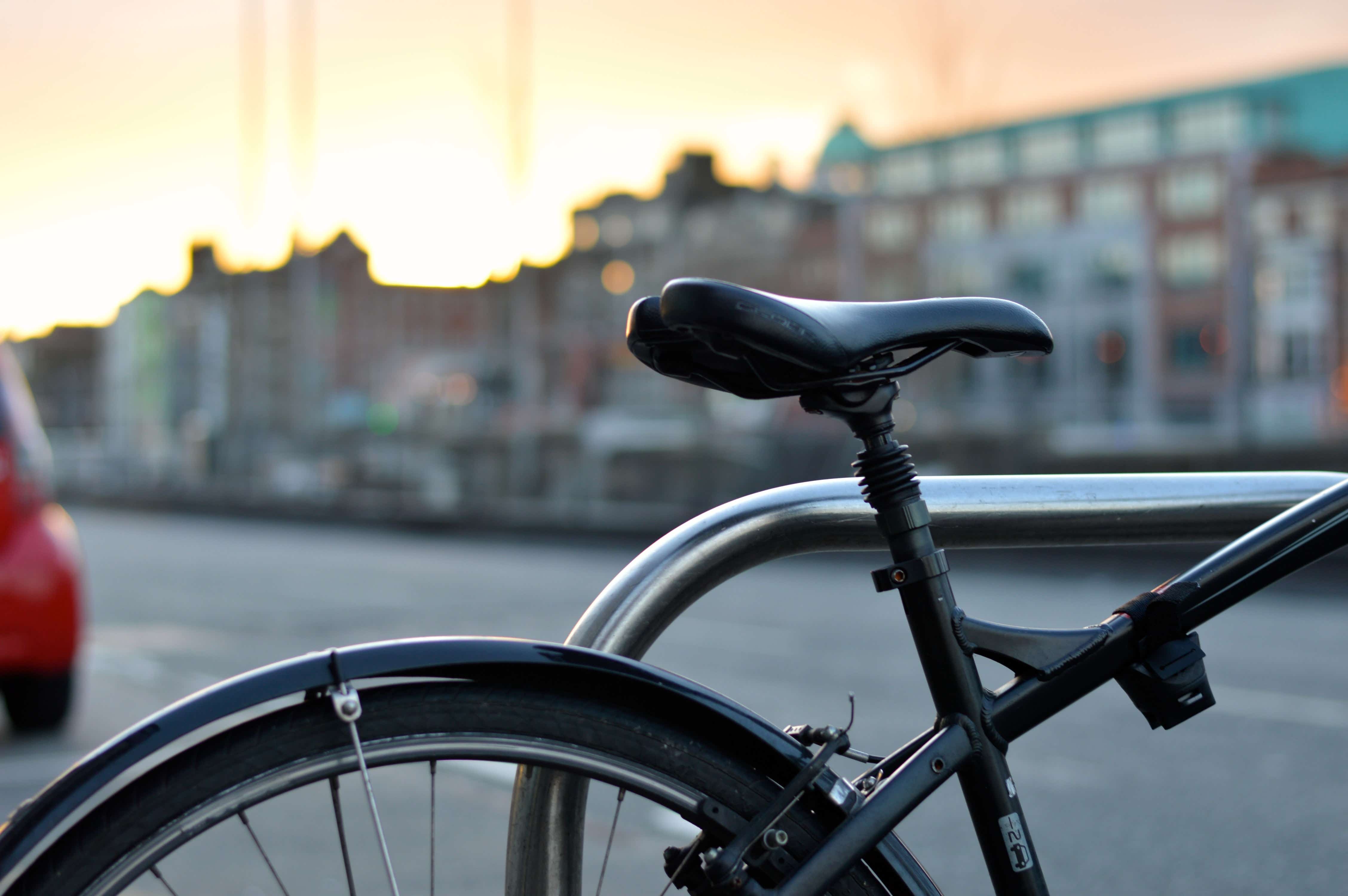 A close up pitcture of a bicycle seat and back tyre.