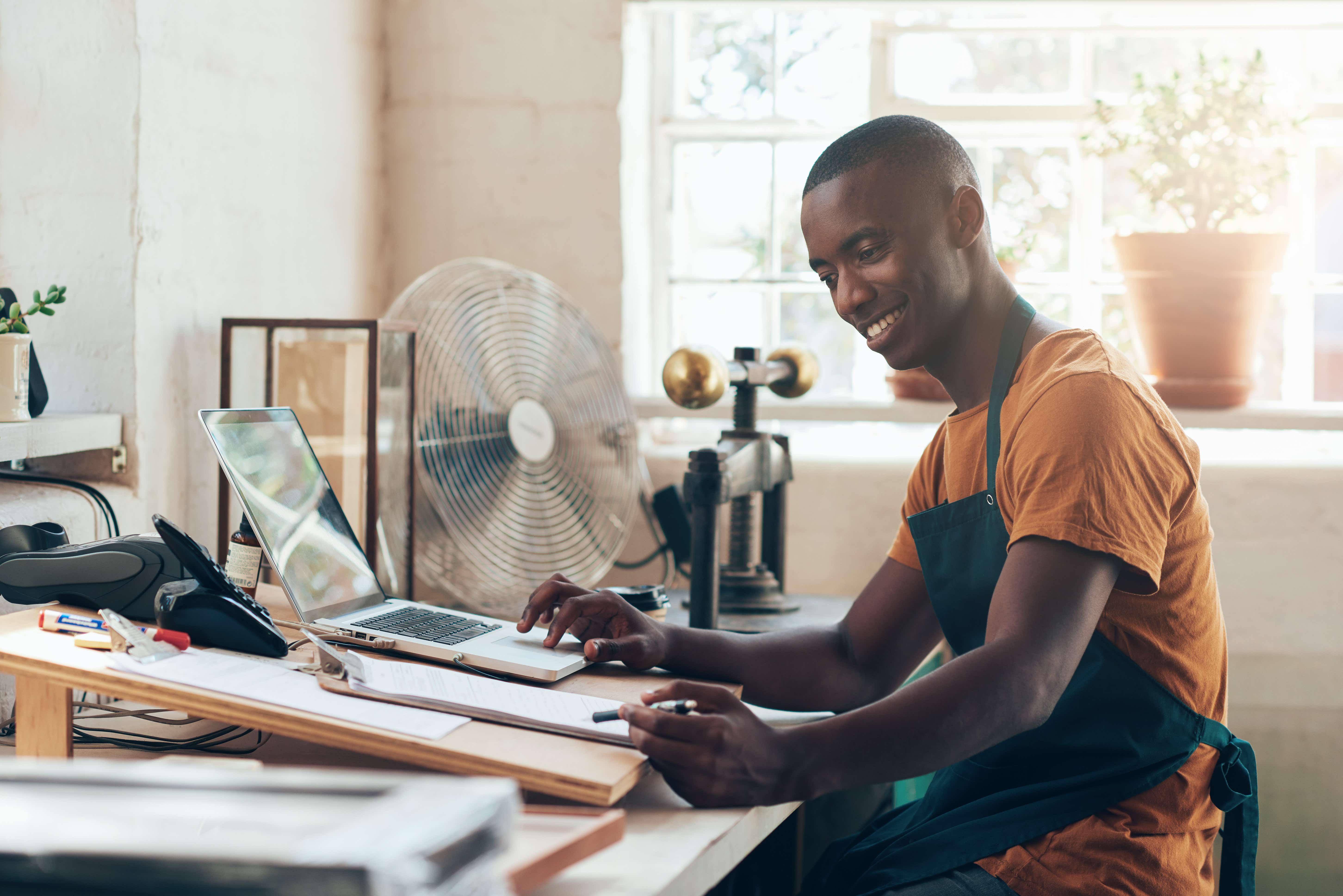 Man writing a business plan, filing accounts for a small business 