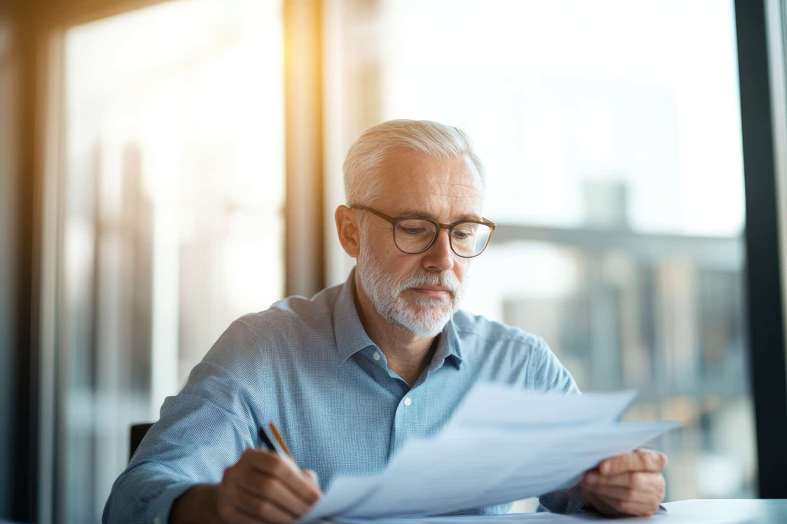 A business owner analysing financial data in a modern office.