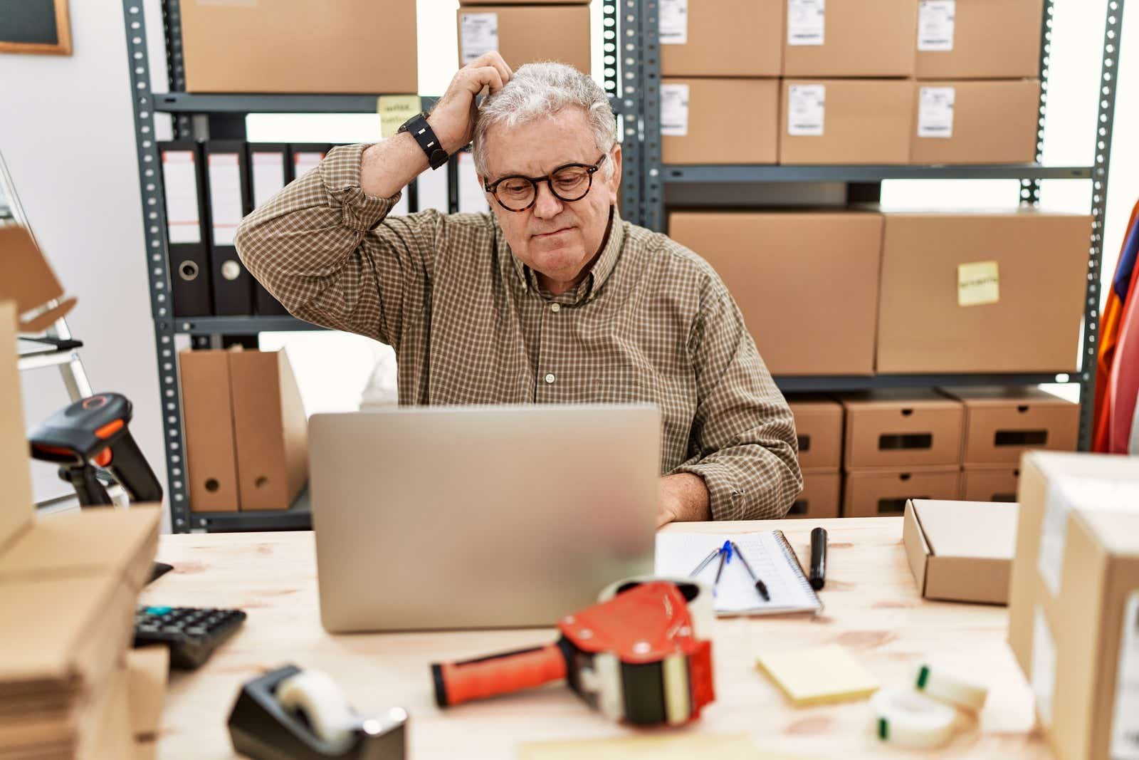 Senior caucasian man working at small business ecommerce with laptop