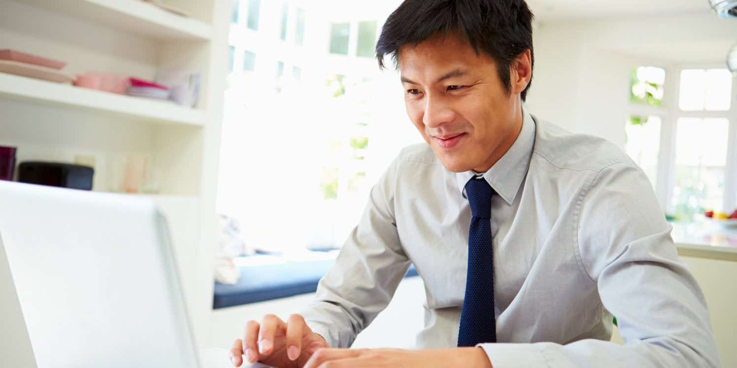 business man at home on laptop