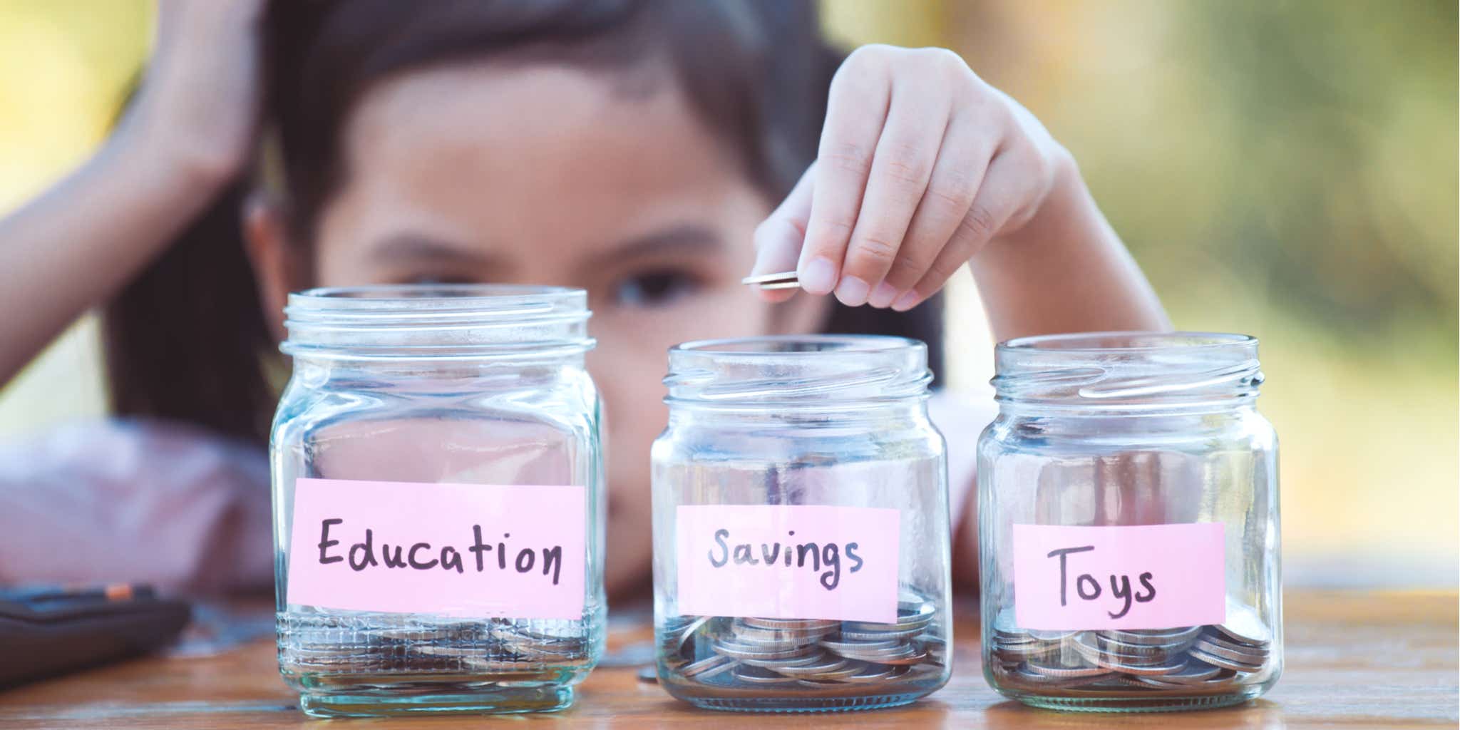 Young girl saving into pots