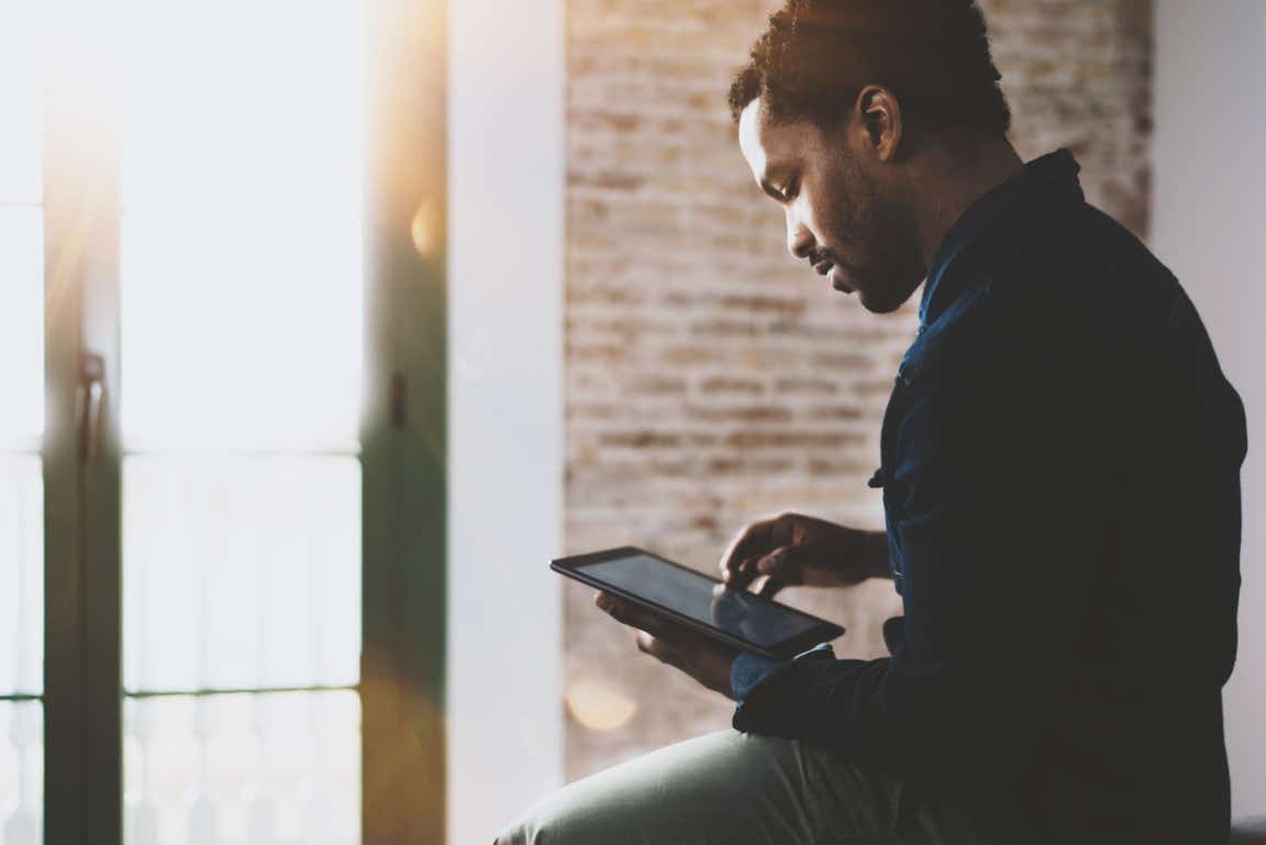 Man looking at his tablet.