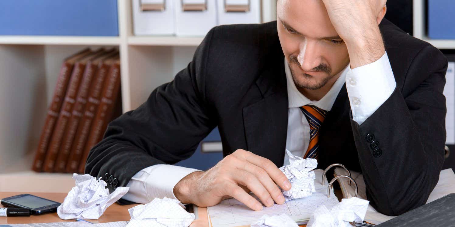 Man at desk looking stressed