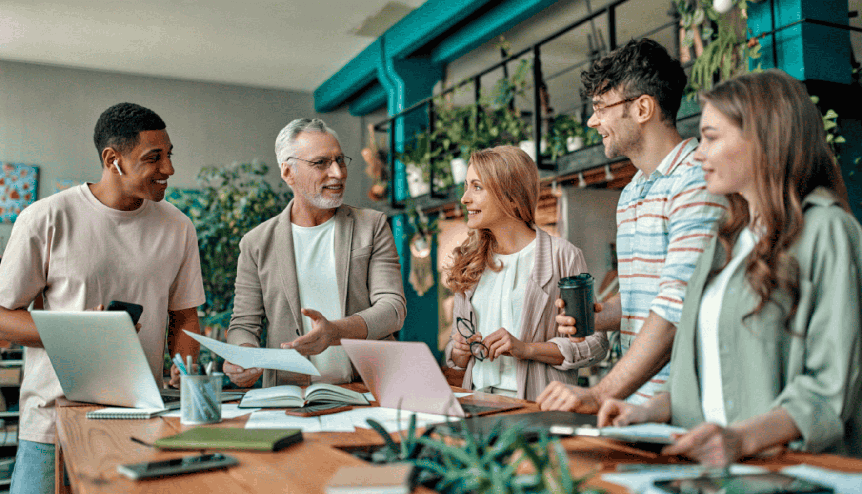A-group-of-employees-gathered-in-a-bright,-modern-office-environment,-engaged-in-conversation