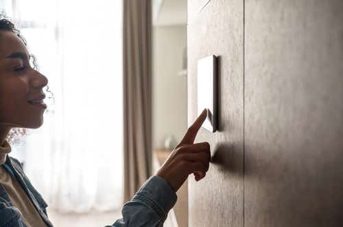 Woman using thermostat