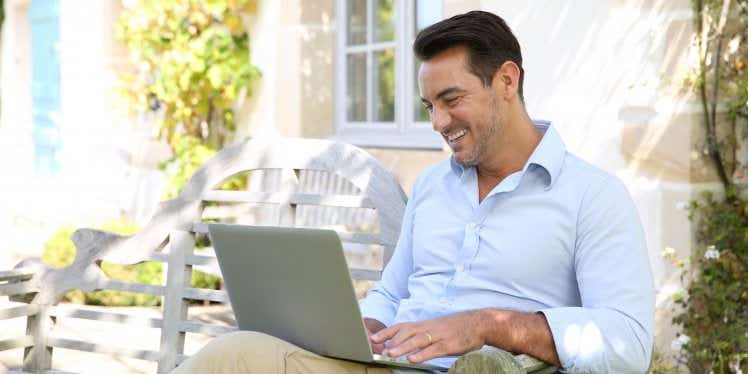 man outside working on laptop