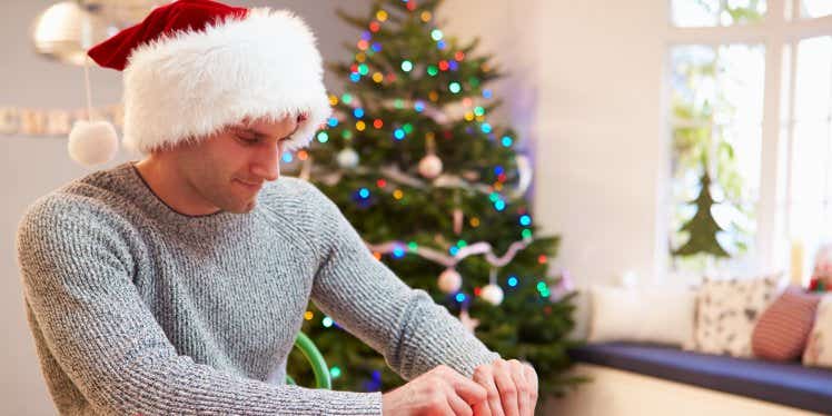 man-wrapping-christmas-presents-at-home