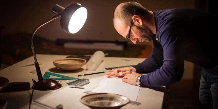 man studying paperwork in dim light