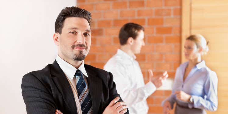 landlord-standing-with-couple-in-distance