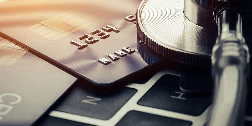 A picture of two credit cards on top of a laptop keyboard