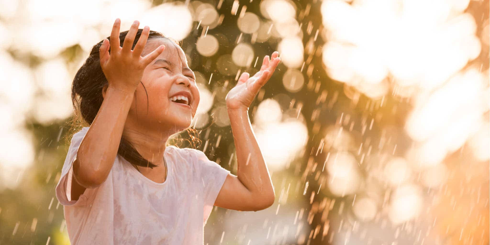 Young girl playing in the rain