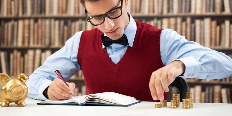 young-man-counting-money-and-writing